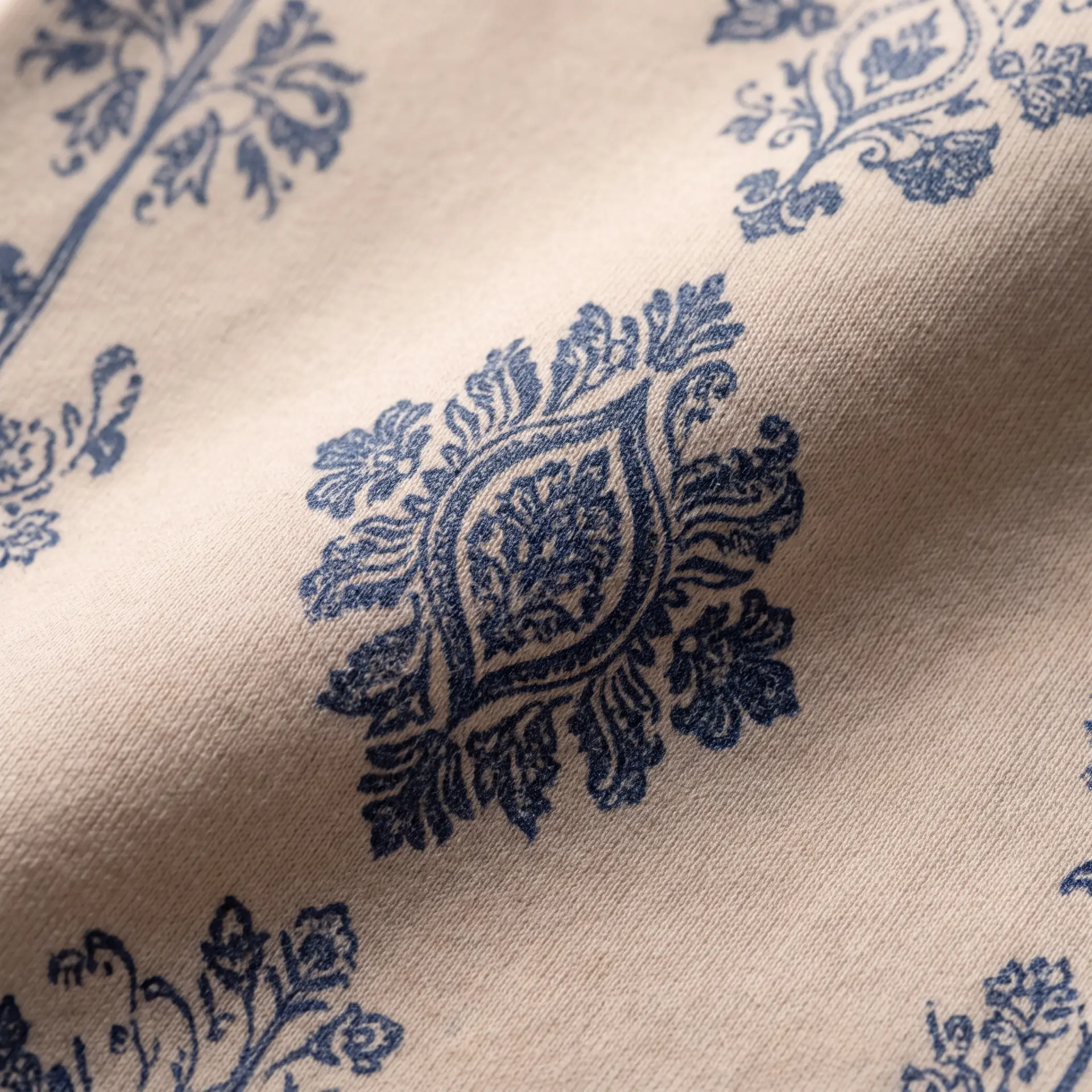 Indigo Indian-inspired motif printed on ivory fabric