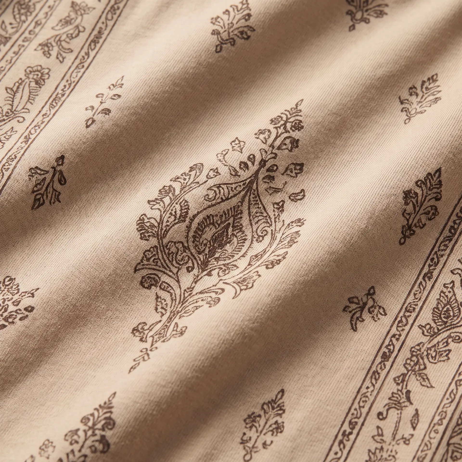 Fine botanical paisley print on soft sand fabric