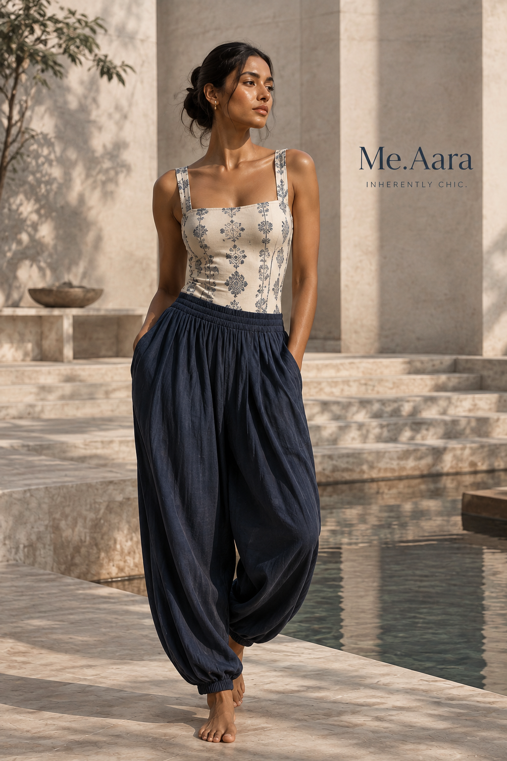 Me.Aara woman wearing an indigo and ivory sculpting look in a limestone courtyard